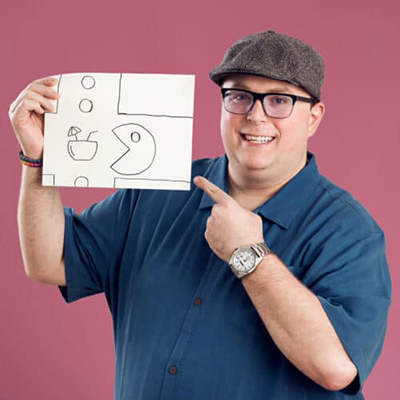 A photo of Mike Demo holding up a drawing of Pac Mac drinking what looks like a cocktail.
