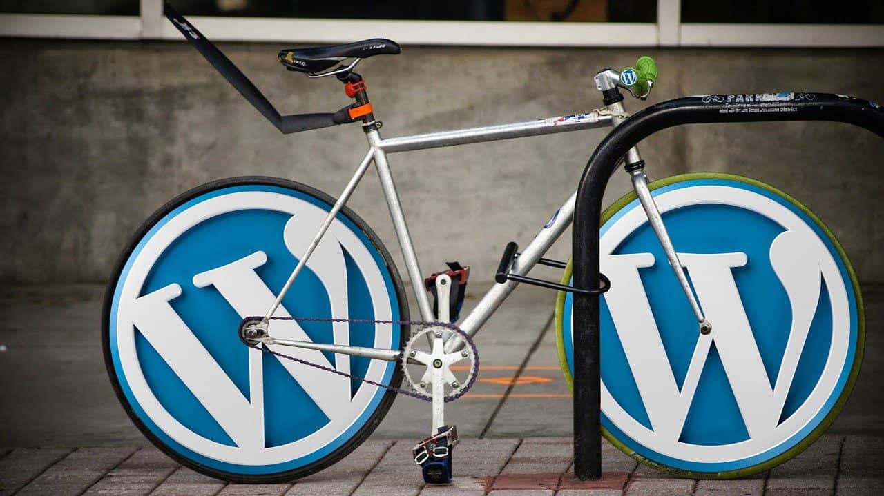 An image of a bike with wheels that have been replaced with the round WordPress logo.