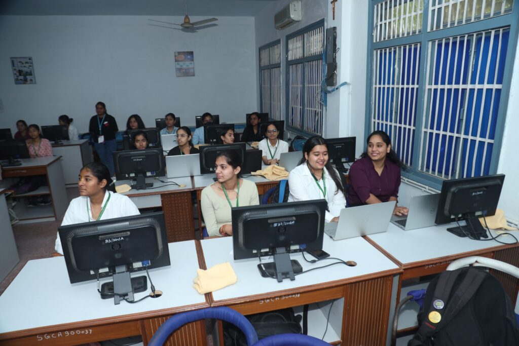 A classroom with students seated at computers, engaged in a learning environment.